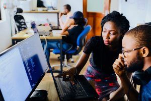 Two people are working together at a computer